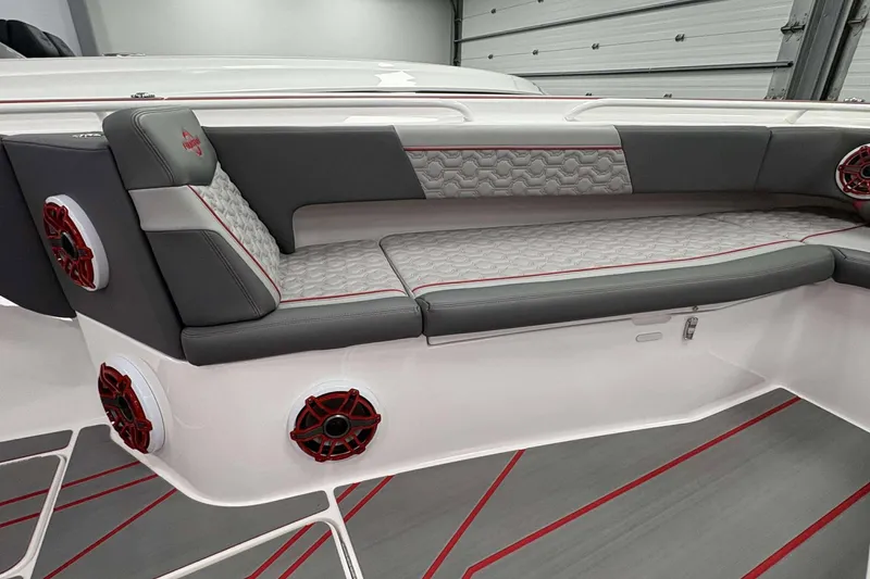Slide: The Image of 2024 Fountain 38 SC boat interior with gray and red seating and speakers. - 28