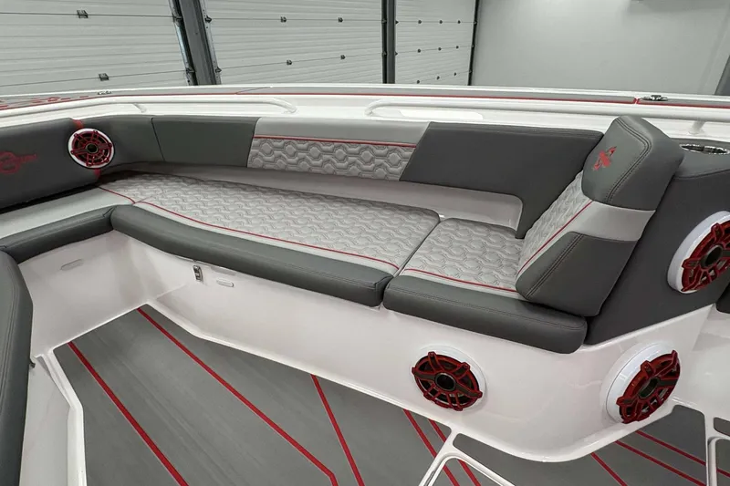 Slide: The Image of 2024 Fountain 38 SC boat interior with gray and red seating, stylish design. - 29