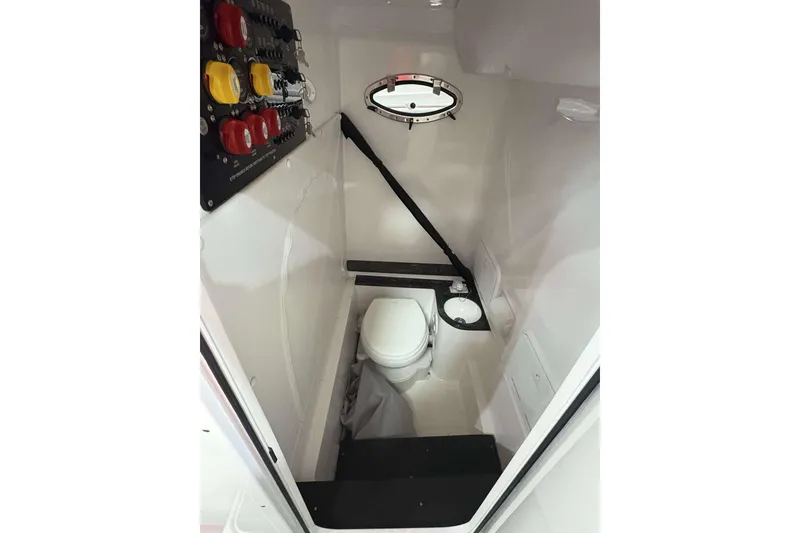 Slide: The Image of 2024 Fountain 38 SC boat interior with toilet and control panel. - 33