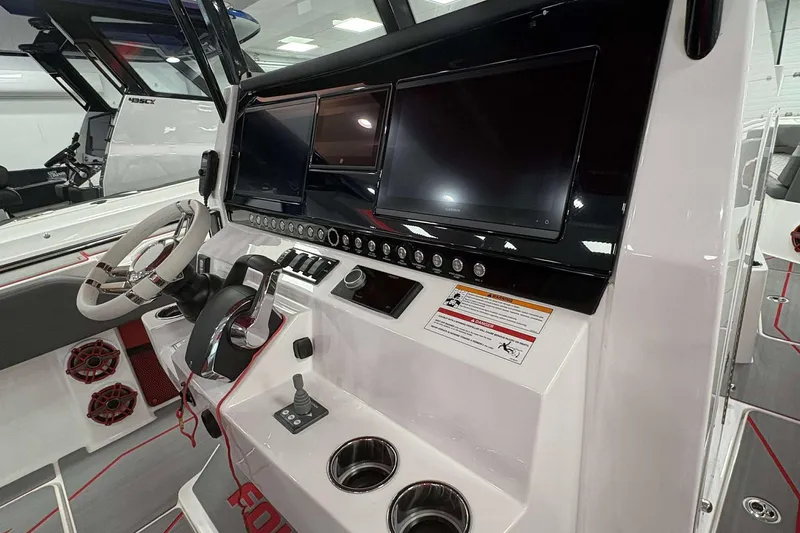 Slide: The Image of 2024 Fountain 38 SC boat dashboard with dual screens and modern controls. - 36