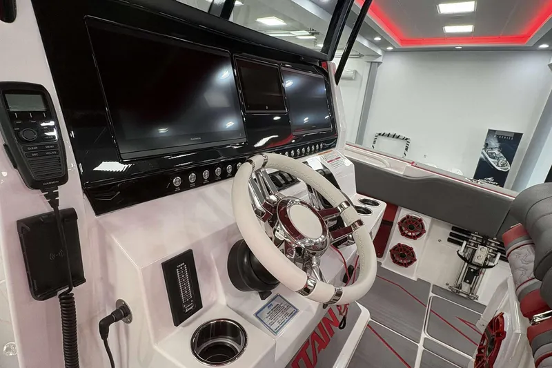 Slide: The Image of 2024 Fountain 38 SC boat dashboard with modern controls and steering wheel. - 37