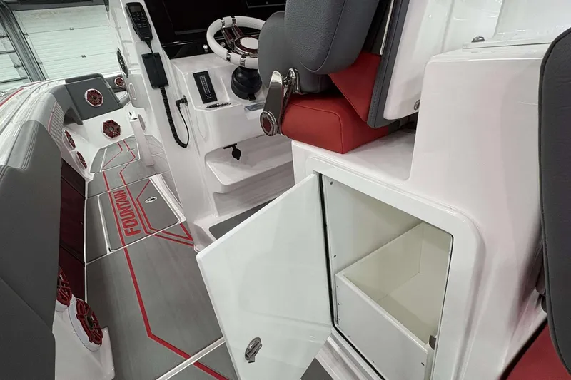 Slide: The Image of 2024 Fountain 38 SC boat interior with open storage compartment and modern seating. - 38