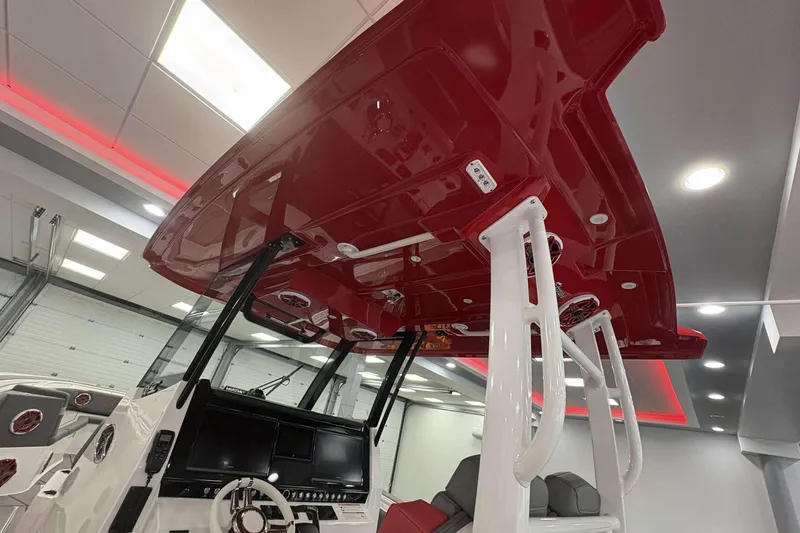 Slide: The Image of 2024 Fountain 38 SC boat interior with red canopy and modern dashboard. - 39