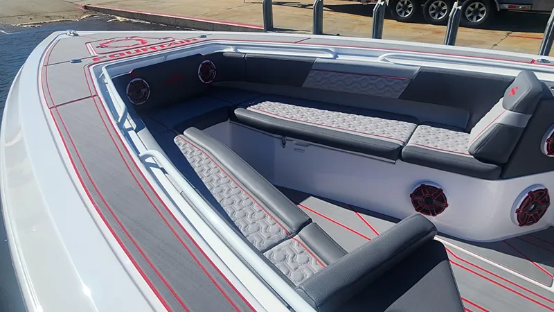 Slide: The Image of 2024 Fountain 38 SC boat interior with gray and red seating. - 6