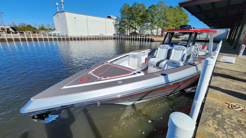 Slide: The Image of 2024 Fountain 38 SCX boat docked by the water. - 11