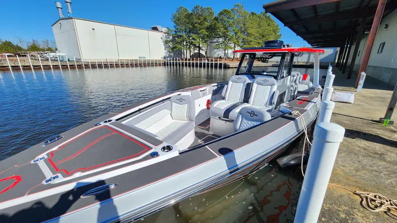 Slide: The Image of 2024 Fountain 38 SCX boat docked by a marina. - 12