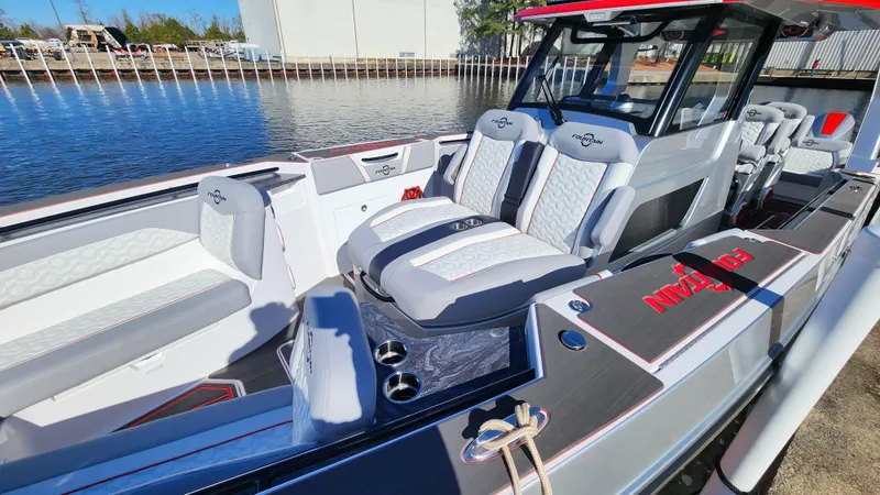 Slide: The Image of 2024 Fountain 38 SCX boat with luxurious seating and modern design docked by the water. - 13
