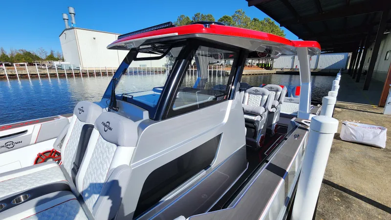 Slide: The Image of 2024 Fountain 38 SCX boat docked near a marina, featuring sleek design and modern amenities. - 15