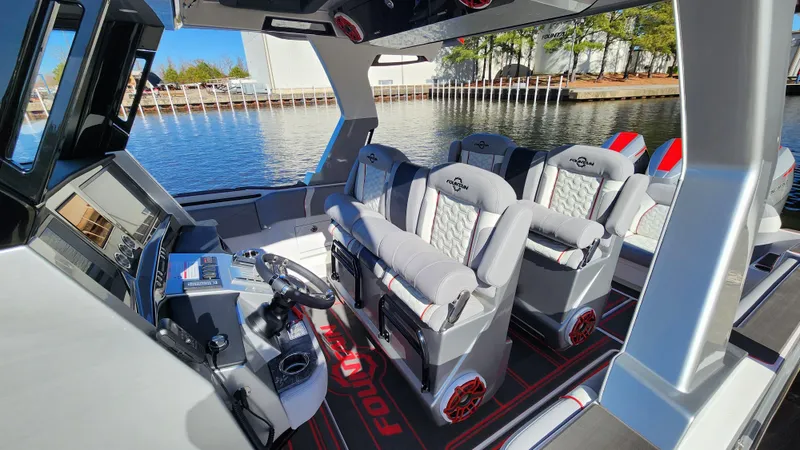 Slide: The Image of 2024 Fountain 38 SCX boat interior with luxurious seating and modern dashboard. - 16