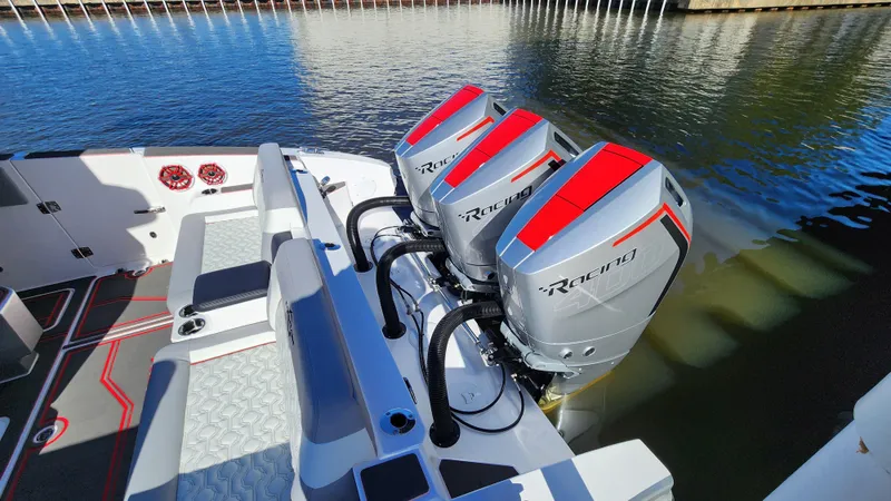 Slide: The Image of 2024 Fountain 38 SCX boat with triple outboard engines docked. - 17
