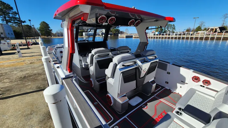 Slide: The Image of 2024 Fountain 38 SCX boat interior at dock, featuring modern seating and sleek design. - 19