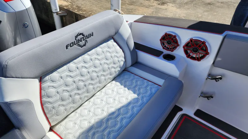 Slide: The Image of 2024 Fountain 38 SCX boat interior with cushioned seating and red speakers. - 5