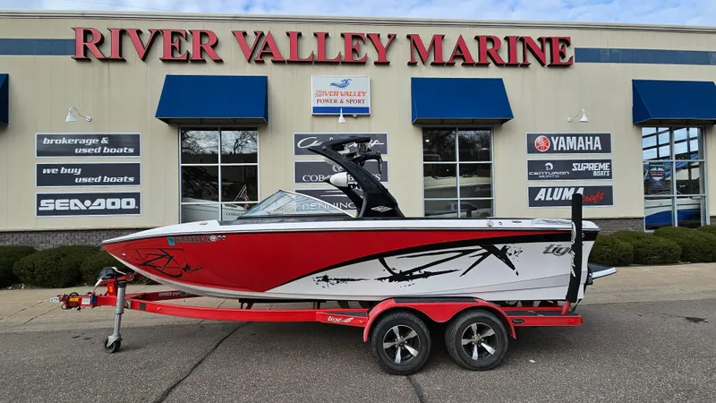The Image of 2013 Tigé Z1 boat on a trailer in front of River Valley Marine. - 1