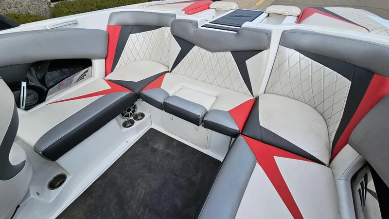Slide: The Image of 2013 Tigé Z1 boat interior with red, black, and white upholstery. - 10