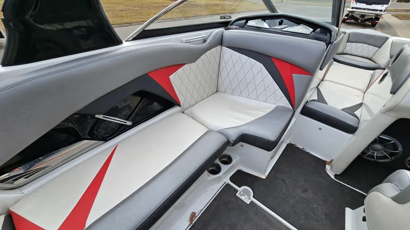 Slide: The Image of 2013 Tigé Z1 boat interior with gray, white, and red upholstery. - 11