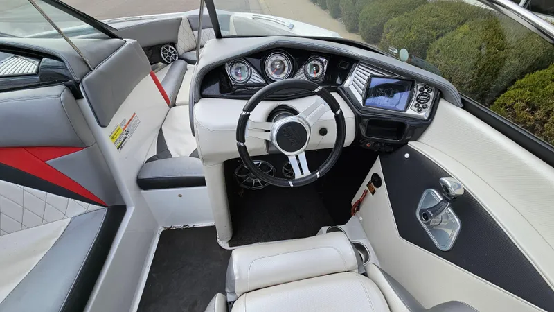 Slide: The Image of 2013 Tigé Z1 boat interior with modern dashboard and steering wheel. - 13