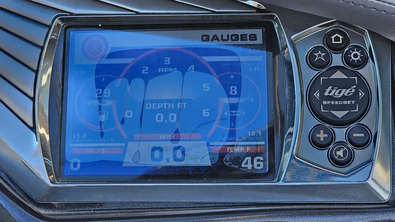 Slide: The Image of 2013 Tigé Z1 boat dashboard with digital gauges and controls. - 17