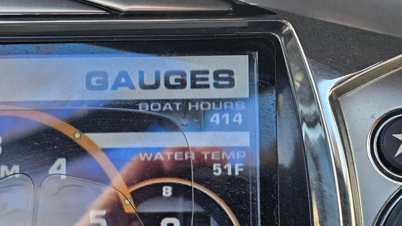 Slide: The Image of Close-up of 2013 Tigé Z1 boat gauge showing 414 hours and 51°F water temperature. - 18