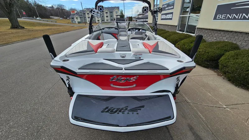 Slide: The Image of 2013 Tigé Z1 boat rear view, parked on a street near a dealership. - 5