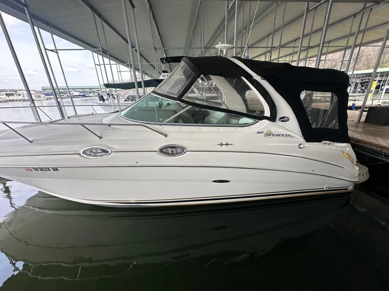 Slide: The Image of 2003 Sea Ray 280 Sundancer boat docked in a covered marina. - 1