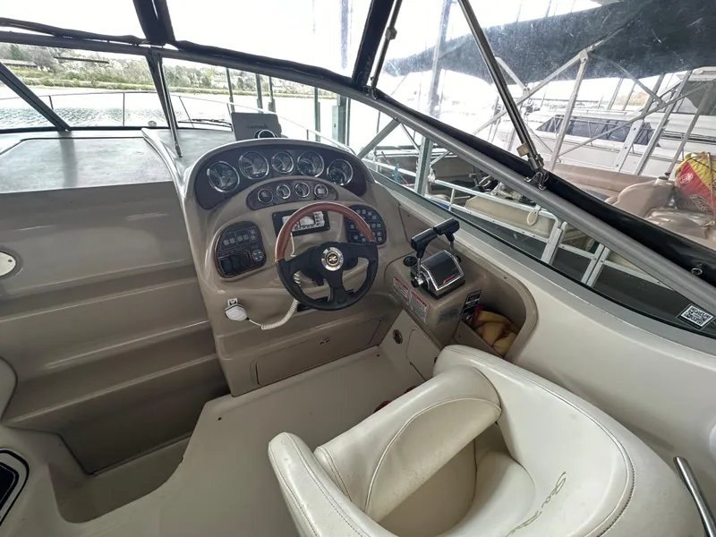 Slide: The Image of 2003 Sea Ray 280 Sundancer helm with steering wheel and instrument panel. - 11