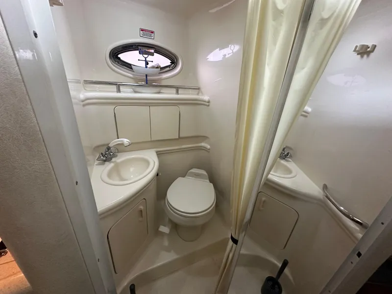 Slide: The Image of Compact bathroom in 2003 Sea Ray 280 Sundancer boat with sink, toilet, and shower. - 17
