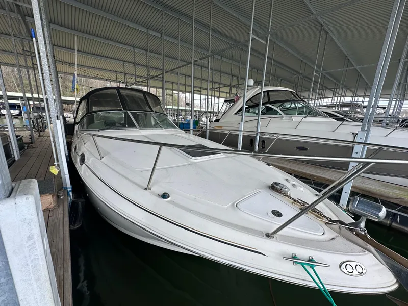 Slide: The Image of 2003 Sea Ray 280 Sundancer docked in a covered marina. - 2