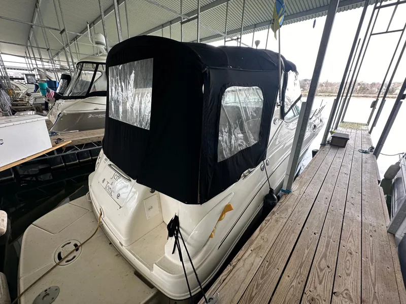 Slide: The Image of 2003 Sea Ray 280 Sundancer docked in a covered marina. - 3