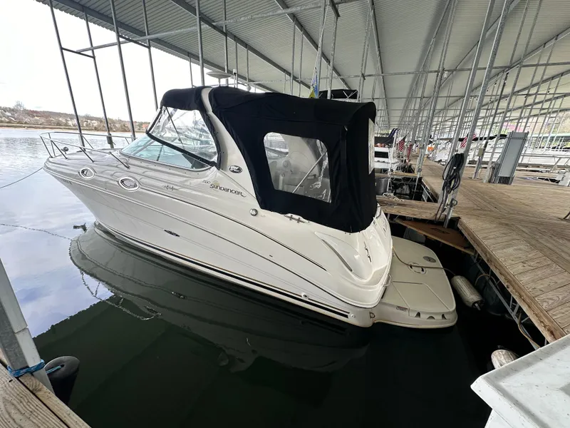 Slide: The Image of 2003 Sea Ray 280 Sundancer docked under a covered marina. - 4