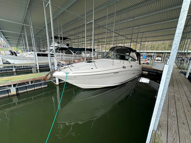 Slide: The Image of 2003 Sea Ray 280 Sundancer docked in a covered marina. - 5