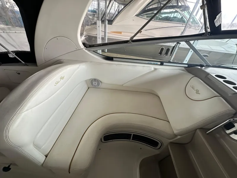 Slide: The Image of 2003 Sea Ray 280 Sundancer interior seating area with white upholstery. - 6