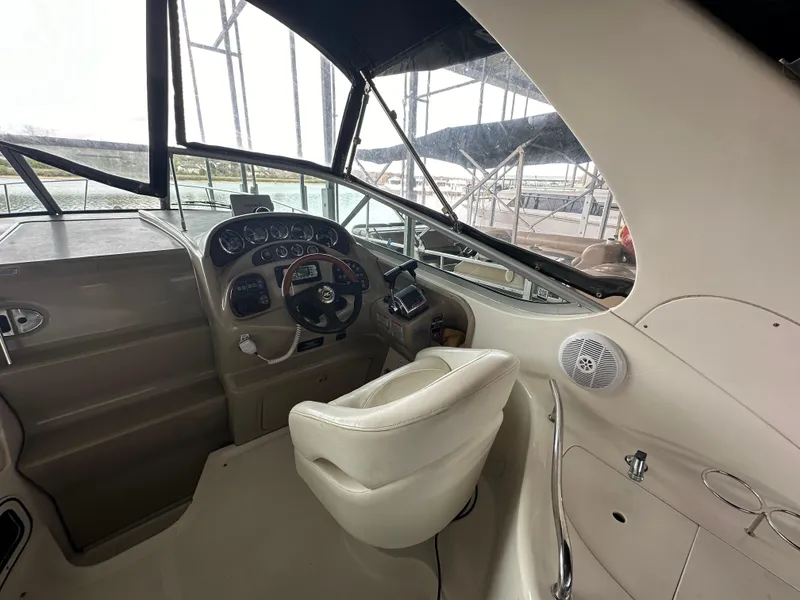 Slide: The Image of 2003 Sea Ray 280 Sundancer boat helm with steering wheel and control panel. - 9