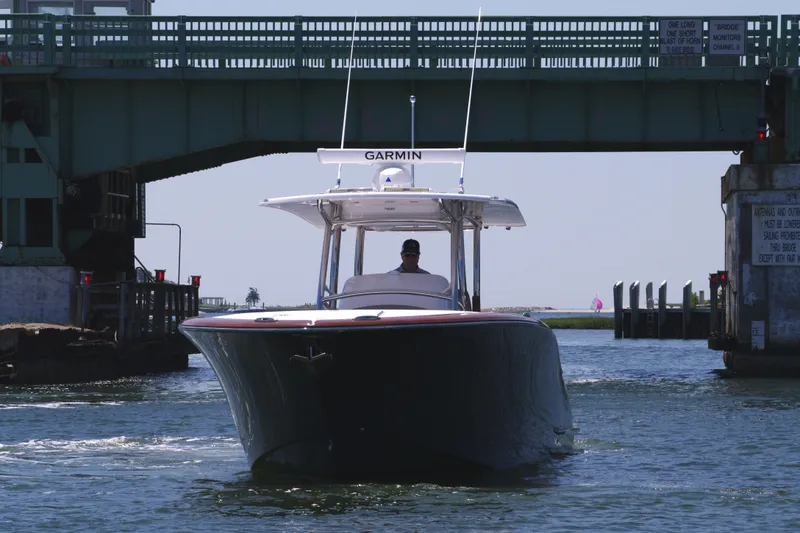 Slide: The Image of 2024 Mag Bay 33 CC boat passing under a bridge. - 2