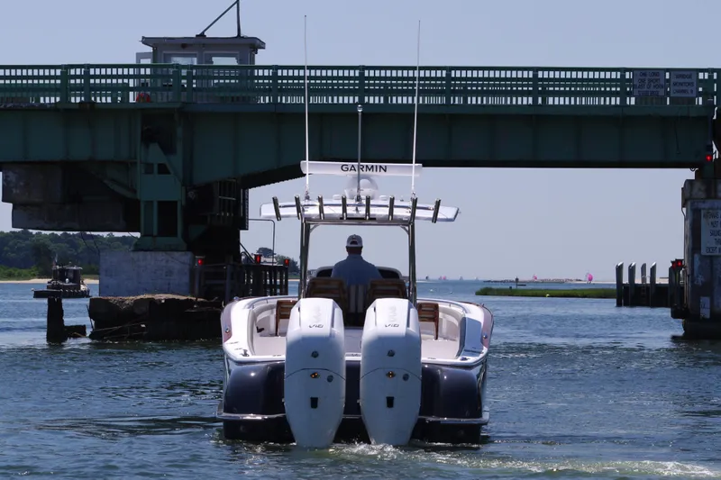 Slide: The Image of 2024 Mag Bay 33 CC boat passing under a bridge. - 6