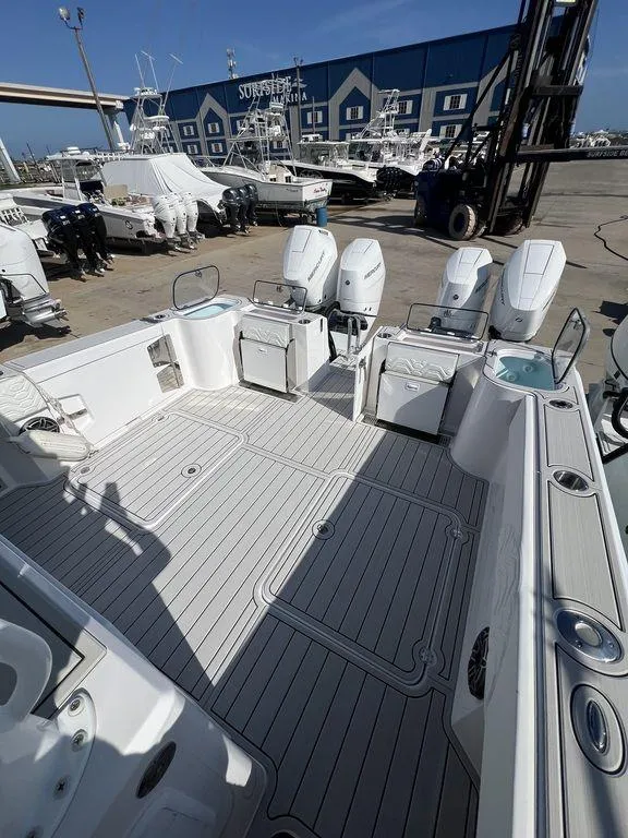 Slide: The Image of 2024 Twin Vee 400 Center Console GFX boat with spacious deck and multiple outboard engines. - 13