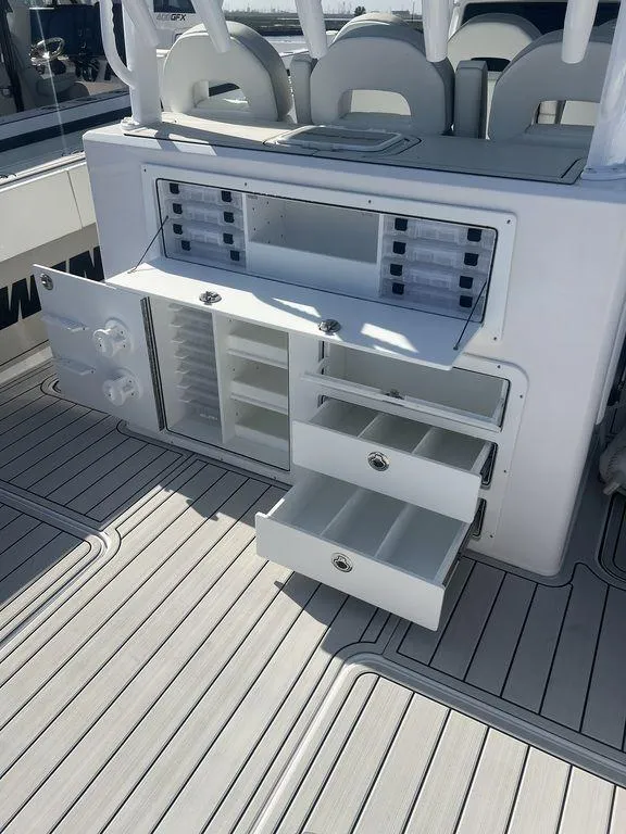 Slide: The Image of 2024 Twin Vee 400 Center Console GFX with open storage compartments and drawers. - 18