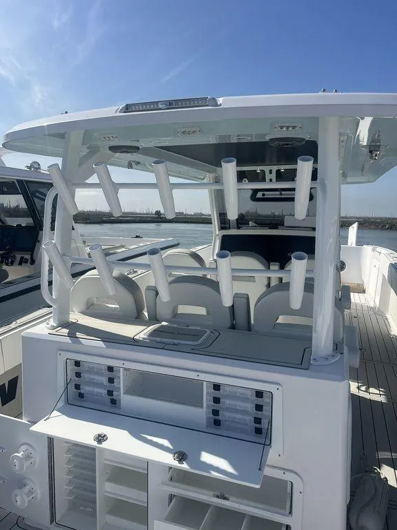 Slide: The Image of 2024 Twin Vee 400 Center Console GFX boat with rod holders and seating. - 20