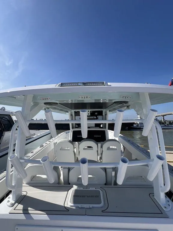 Slide: The Image of 2024 Twin Vee 400 Center Console GFX boat with rod holders and seating. - 24