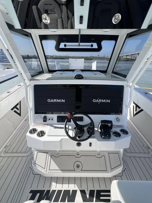 Slide: The Image of 2024 Twin Vee 400 Center Console GFX boat helm with Garmin navigation displays. - 26