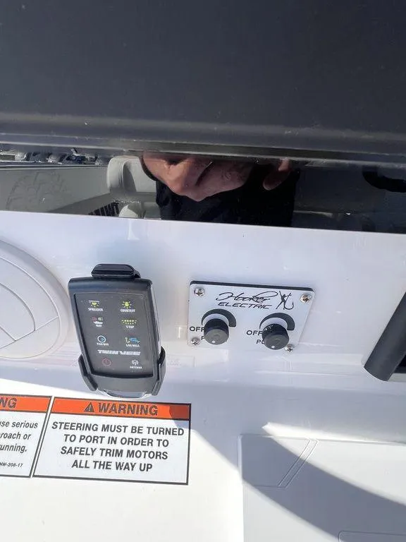 Slide: The Image of 2024 Twin Vee 400 Center Console GFX boat control panel with warning label. - 28