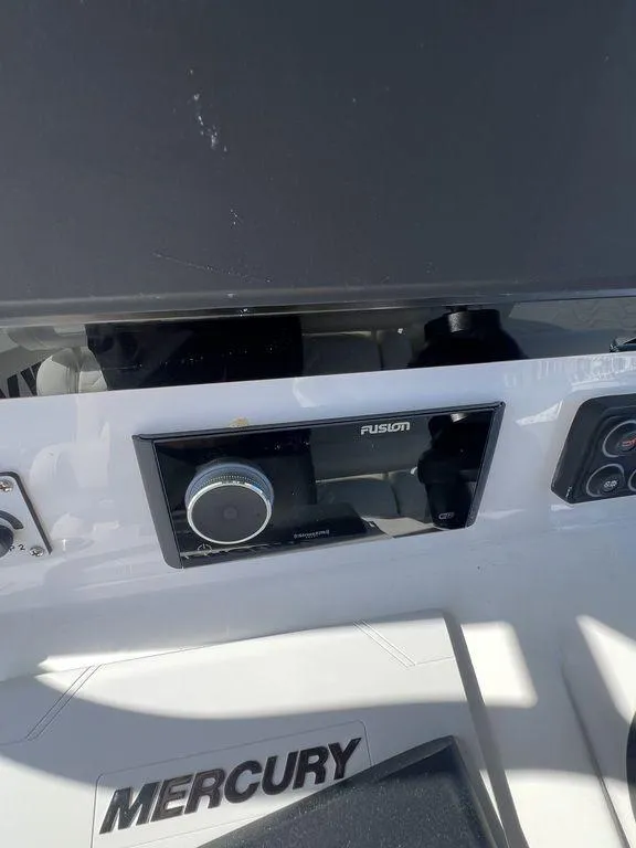 Slide: The Image of 2024 Twin Vee 400 Center Console GFX dashboard with Fusion stereo and Mercury controls. - 30