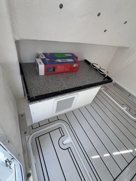 Slide: The Image of 2024 Twin Vee 400 Center Console GFX interior storage area with countertop and flooring. - 36