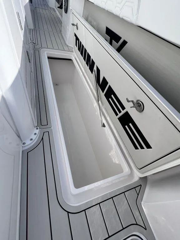 Slide: The Image of 2024 Twin Vee 400 Center Console GFX boat storage compartment and deck. - 37