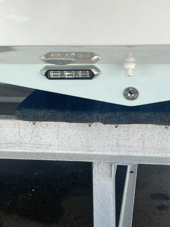 Slide: The Image of 2024 Twin Vee 400 Center Console GFX boat on a trailer, close-up of stern light. - 7