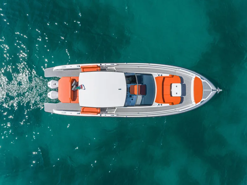 Slide: The Image of 2024 Rio Yachts Daytona 35 cruising on clear turquoise water, aerial view. - 10