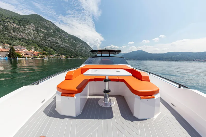Slide: The Image of 2024 Rio Yachts Daytona 35 with orange seating, scenic mountain and lake view. - 12