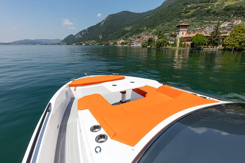 Slide: The Image of 2024 Rio Yachts Daytona 35 with orange seating, cruising on a scenic lake. - 14