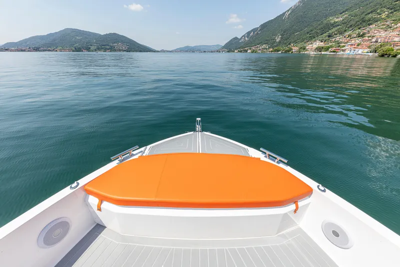 Slide: The Image of 2024 Rio Yachts Daytona 35 cruising on a serene lake with mountainous backdrop. - 15