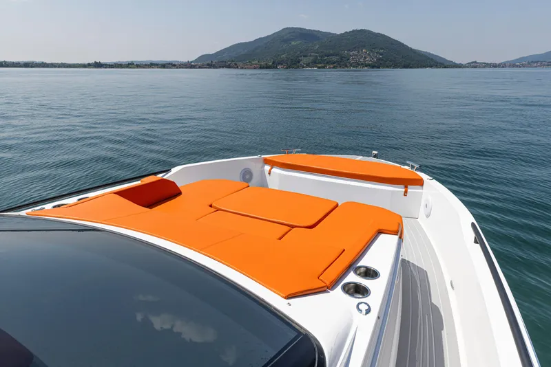 Slide: The Image of 2024 Rio Yachts Daytona 35 with vibrant orange seating on calm waters. - 17