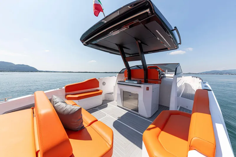 Slide: The Image of 2024 Rio Yachts Daytona 35 with vibrant orange seating and sleek design on open water. - 22